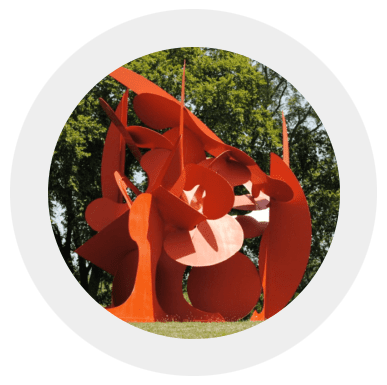 A picture of an orange sculpture in the shape of a person.